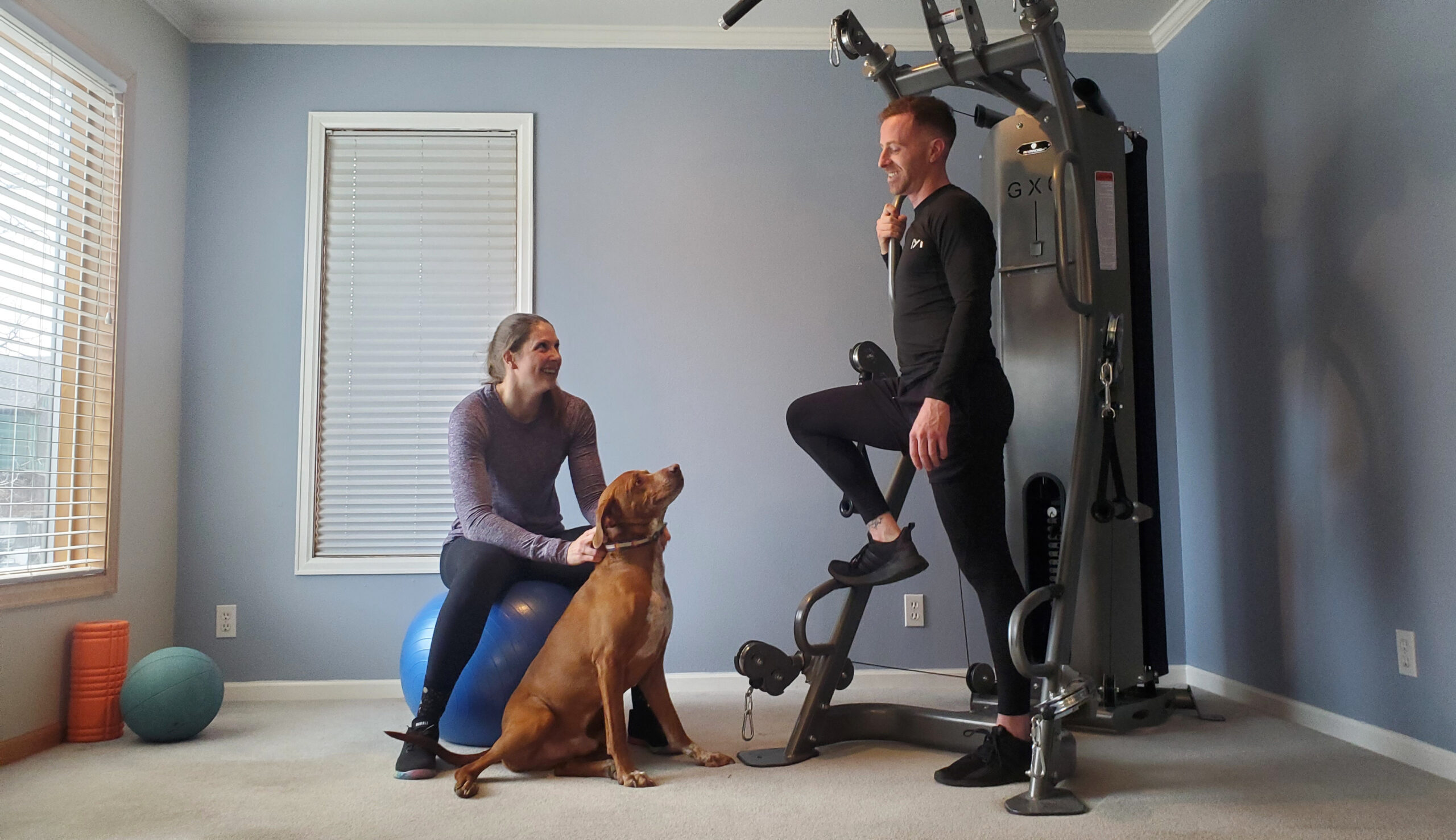 A young couple and their dog enjoy their Paradigm Fitness Equipment GX6 Home gym together. 